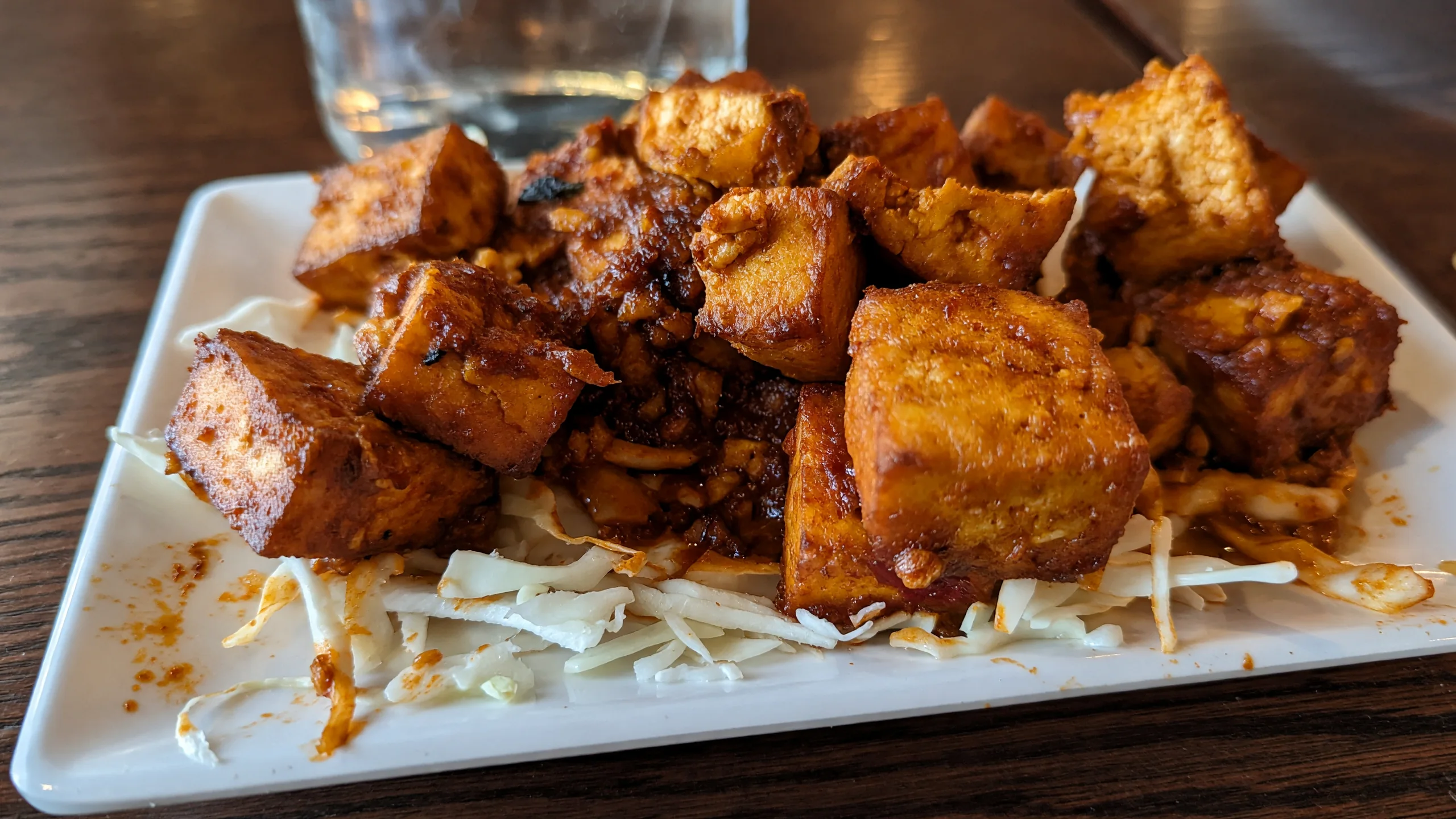 Spicy fried paneer cubes on shredded cabbage at Bawarchi in Mississauga